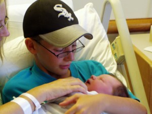 Noah holding his new sister